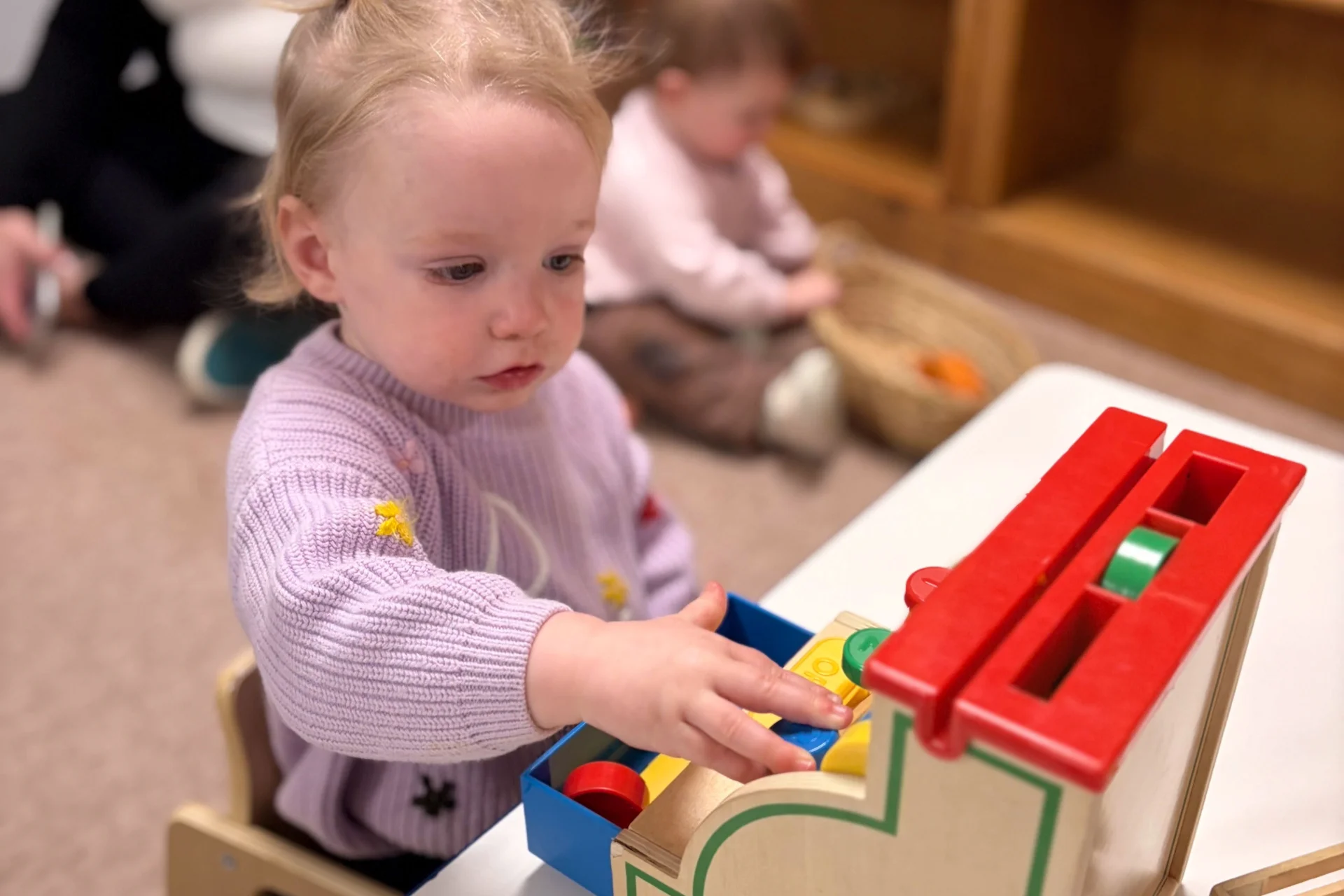toddler playing music at school